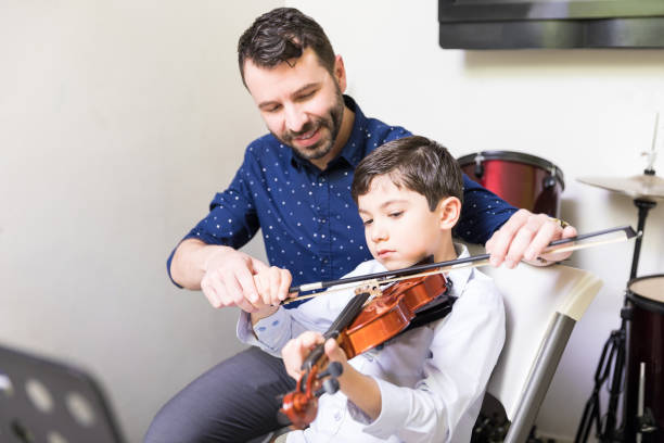 istock Teacher Sharing His Technique Of Playing Violin 1132660335