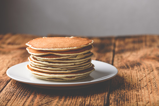 Stack of american pancakes on white plate
