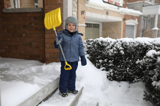 man shoveling snow in sunny day