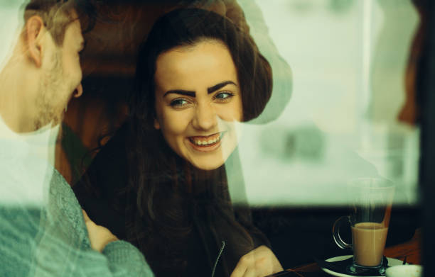 istock Young couple talking and laughing in a cafe 1132666055