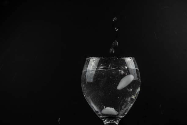 Ice splashing in a glass of water