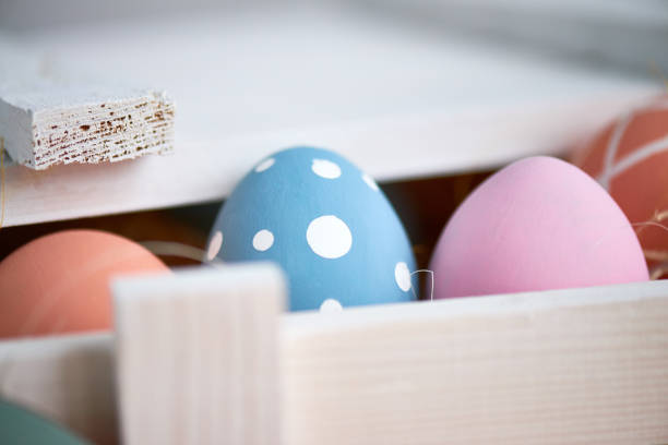 istock Bright colorful Easter eggs in wooden box, macro effect 1132671511