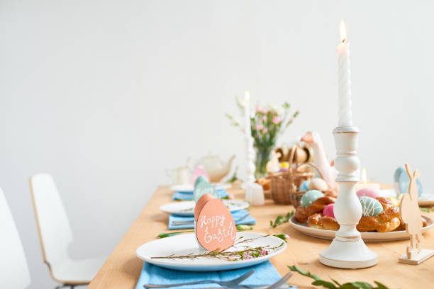 istock Easter table setting with greeting cards, spring flowers, traditional dishes and decorations in shape of animals 1132671586