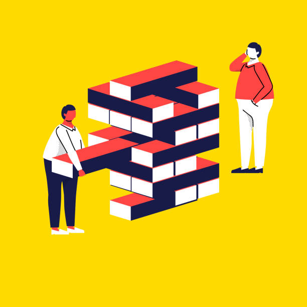 istock Office life, two male workers playing game conveying the message of  taking risks of running a business 1132671712