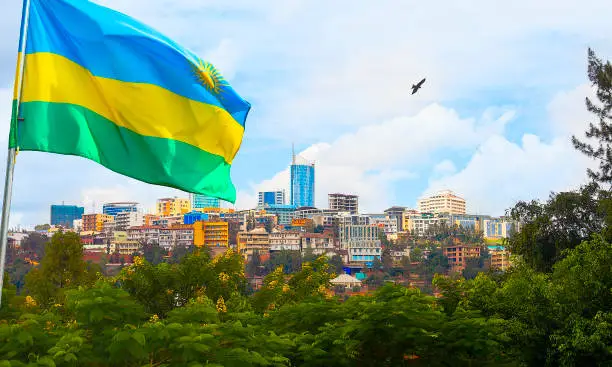 View of Kigali business district with offices, towers and residential homes, and Rwanda's flag.