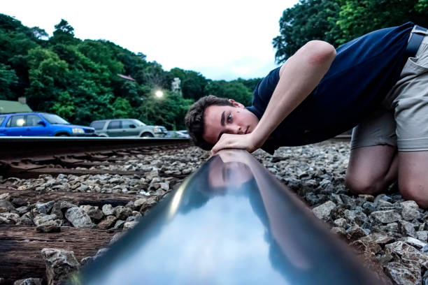 HARPERS FERRY WEST VIRGINIA USA Listening to tracks and penny flattening by train
