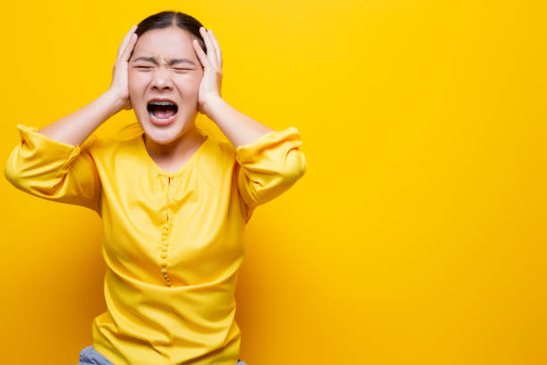istock Angry woman screaming isolated over yellow background 1132674603