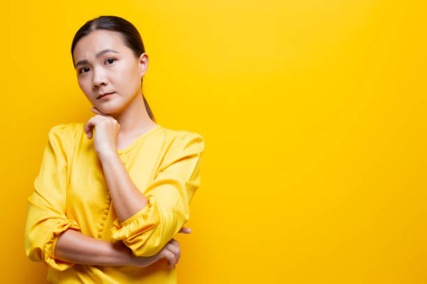 istock Sad woman isolated over yellow background 1132675129