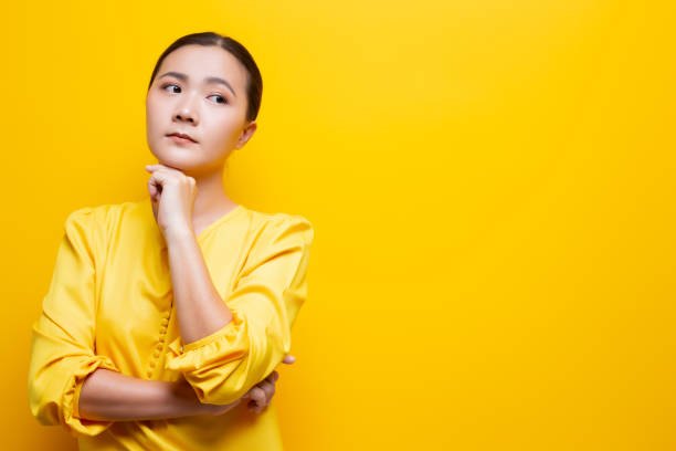 istock Sad woman isolated over yellow background 1132675134
