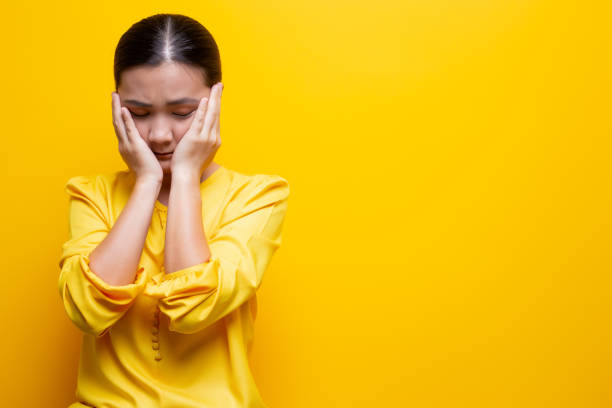 istock Sad woman isolated over yellow background 1132675190