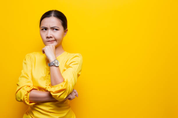 istock Woman feel confused isolated over yellow background 1132675230