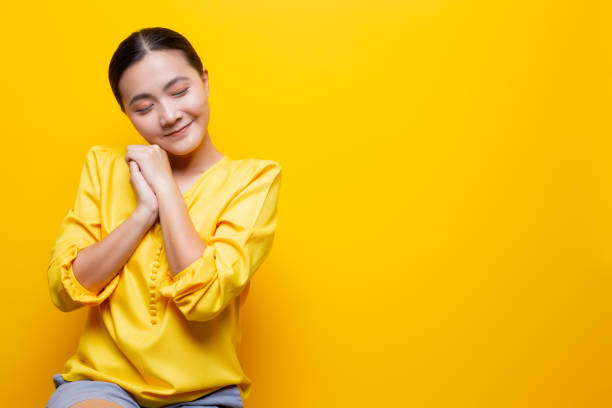 istock Woman feel shy standing isolated over yellow background 1132675302