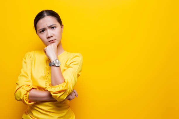 istock Woman feel confused isolated over yellow background 1132675357