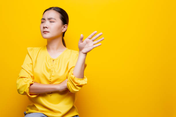 istock Angry woman standing isolated over yellow background 1132675453