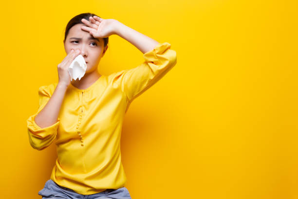 Woman use tissue paper after she sneezing