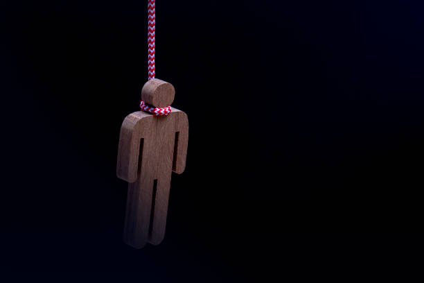 Wood figure hanged with a rope Isolated on black background, emotional stress and Suicide concept Wood figure hanged with a rope Isolated on black background, emotional stress and Suicide concept silhouette of the hanging noose stock pictures, royalty-free photos & images