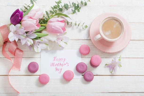 istock Tulips and cup of coffee with dessert on white background. Conce 1132680164