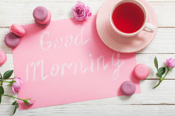 istock cup of tea and pink macaroons on white wooden table 1132680168