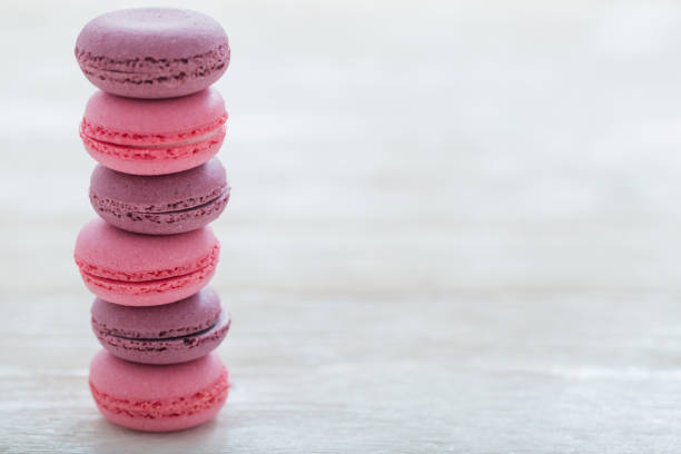 istock pink macaroons on wooden background 1132680199