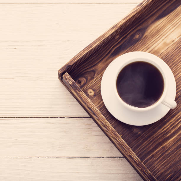 istock cup of coffee on tray on wooden table 1132680571