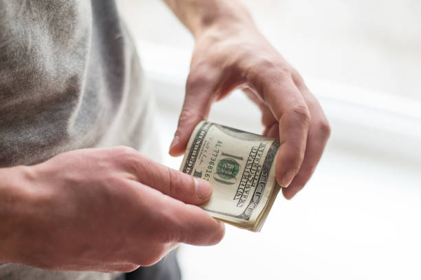 istock Man's hands with dollars on white background. Financial business concept. 1132682394