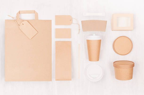 istock Food branding identity mockup in light modern style - blank coffee cup, packet, bag, box, label, card of brown paper  on white wood board. 1132685414