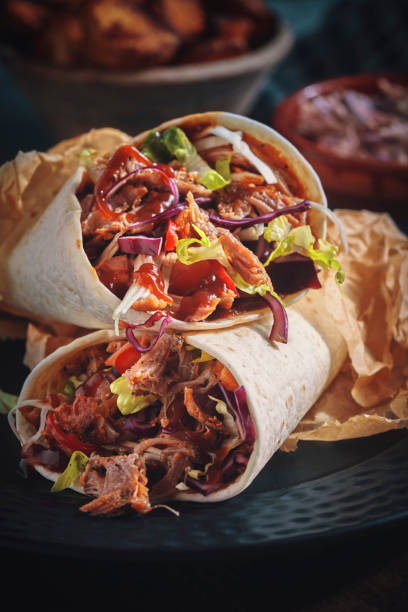 istock Pulled Pork Wrap Sandwich with Tomato, Salad and Chili 1132690883