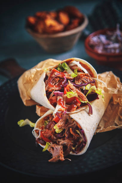 istock Pulled Pork Wrap Sandwich with Tomato, Salad and Chili 1132690885