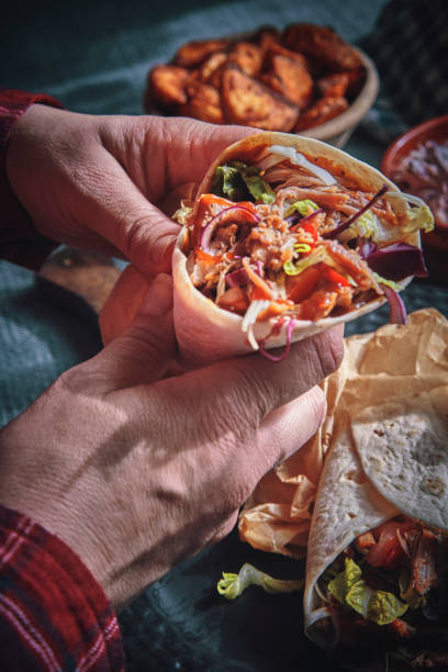 istock Pulled Pork Wrap Sandwich with Tomato, Salad and Chili 1132690894