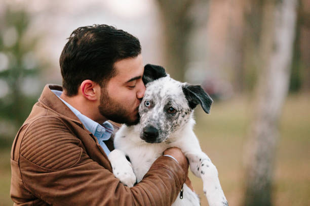 istock young man and his mixed-breed puppy in the park 1132691191