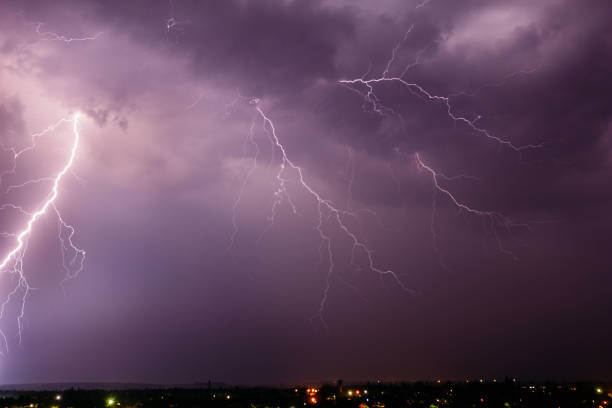 istock Thunderstorm with lightning in the sky over a small town 1132694525