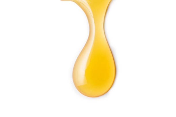 istock Macro one honey drops isolated on white background, File contains a clipping path. 1132699582