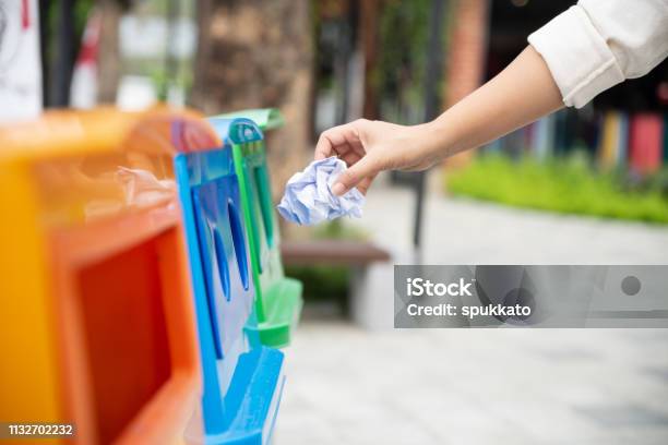 Closeup Portrait Woman Hand Throwing Crumpled Paper In Recycling Bin Stock Photo - Download Image Now