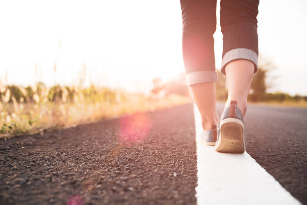 istock Closeup woman walking towards on the road side. Step concept. 1132702412