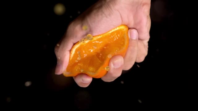 Slow motion: Orange squeeze on top of camera view.