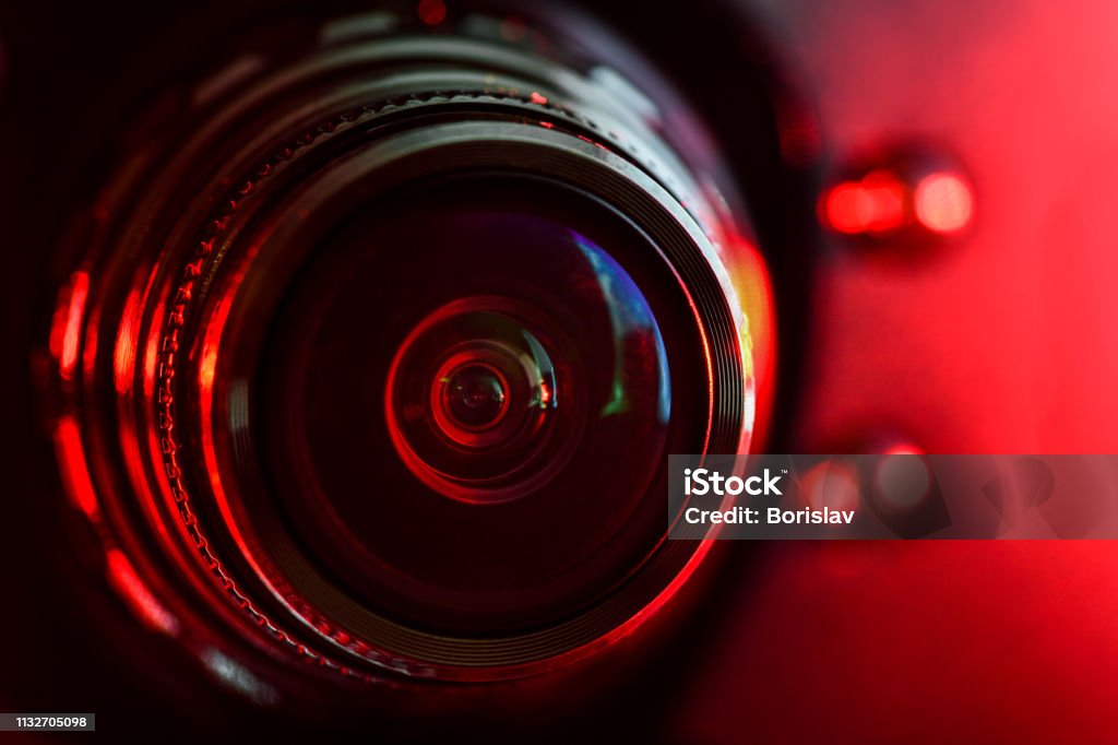 Camera lens and red backlight . Horizontal photography Body Camera Stock Photo
