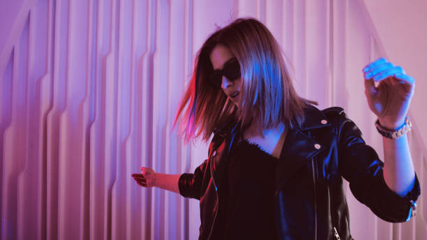 istock Beautiful girl dancing in retro wave on the neon light 1132705148