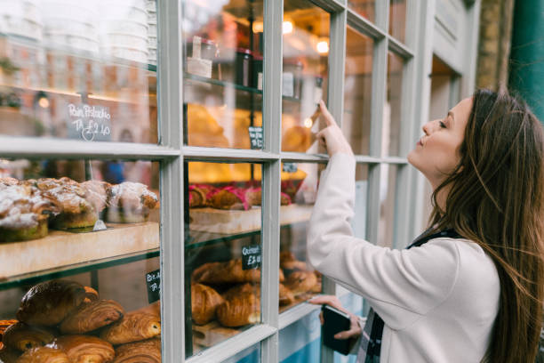 hungry woman at the bakery - cake pick imagens e fotografias de stock