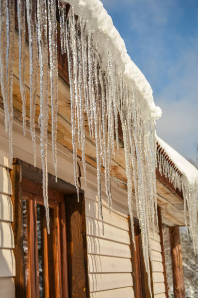istock Icicles on a sunny day hang from a heated roof 1132712973