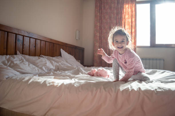 istock Beautiful girl playing on the bed 1132713021