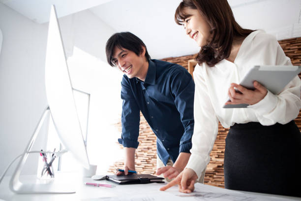 managers checking the finished drawings with a pc monitor - corporate business manager manual worker architect imagens e fotografias de stock