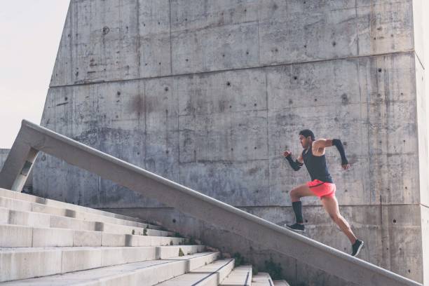 istock Muscular hispanic Young man training working out outdoors.Concret background wall with copy space area for text message or advertising content. 1132714724