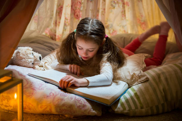 istock Cute little girl read big book 1132714763