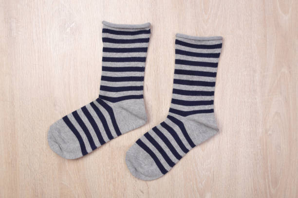istock Gray blue navy stripes socks on wooden background 1132715216