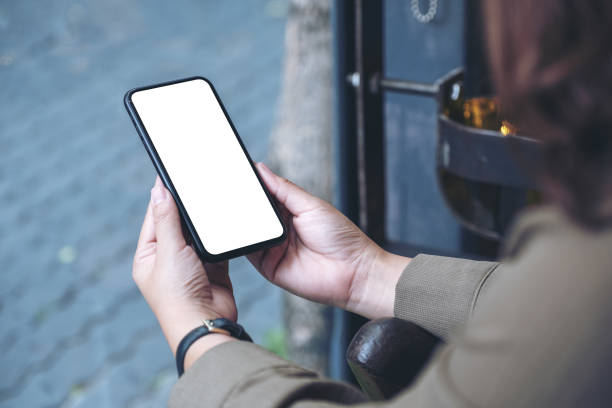 istock Mockup image of hands holding black mobile phone with blank desktop screen 1132719939