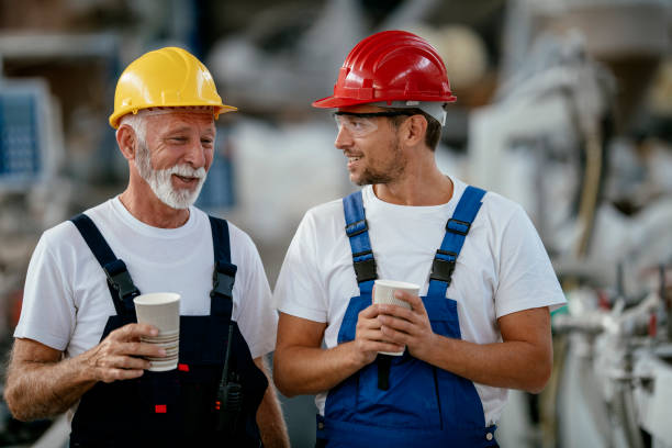 istock Manual workers having a coffee break in industrial building 1132720090