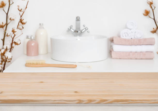 istock Wooden table top and blur bathroom interior on the background 1132720100