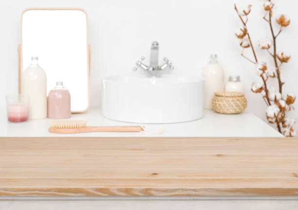 Wooden table top for product display and blurred bathroom background
