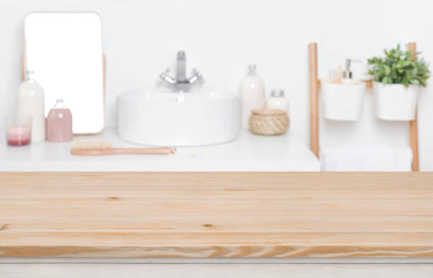 istock Wooden tabletop for product display over defocused bathroom interior background 1132720171
