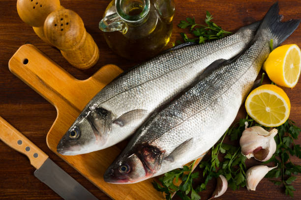 istock Cutting board with uncooked sea bass 1132720191